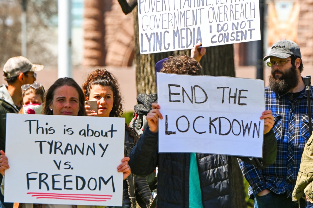 Protesters at Queen's Parki on Saturday, April 25 demand an end to public health rules put in place to stop the spread of COVID-19.