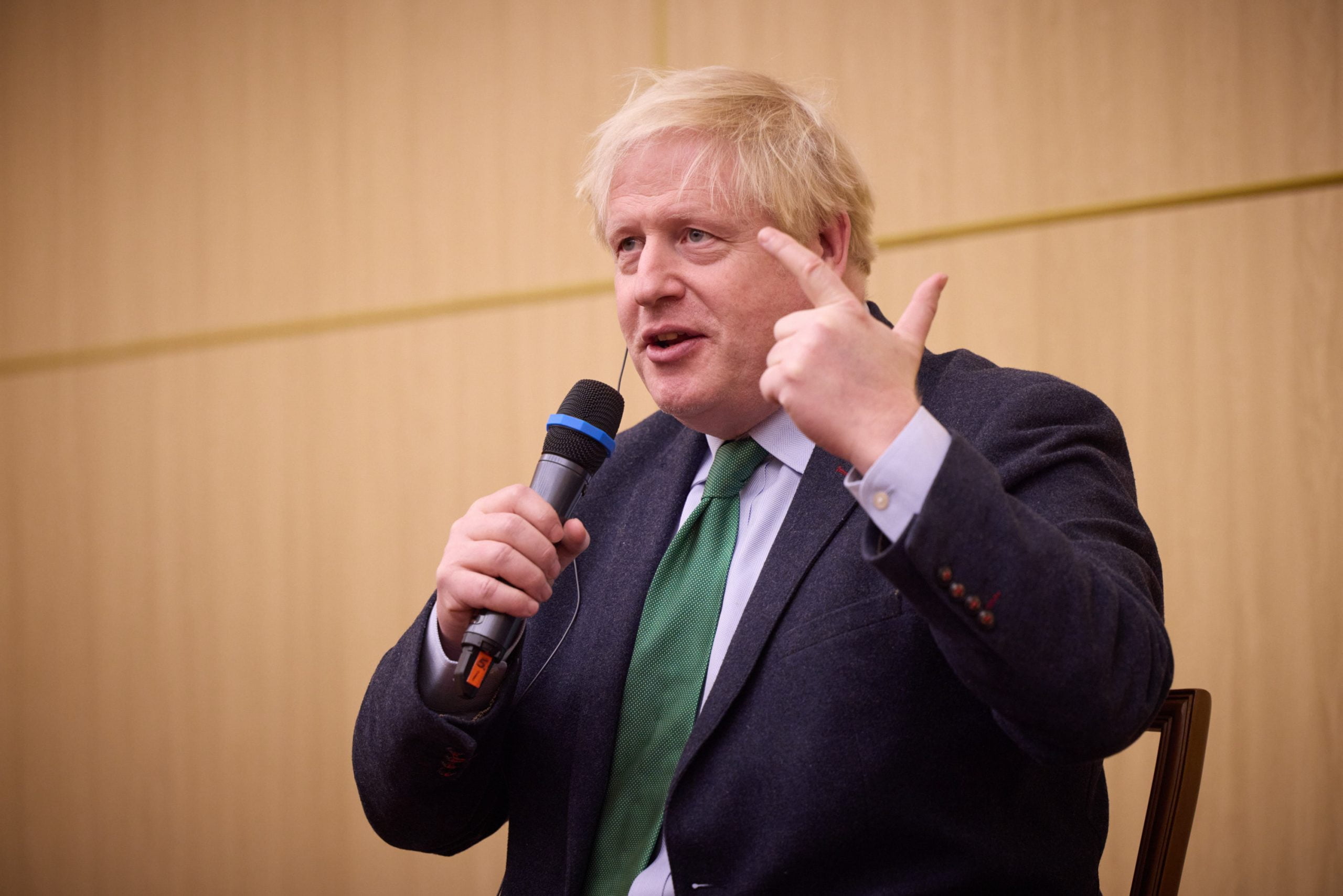 Boris Johnson speaking into a microphone